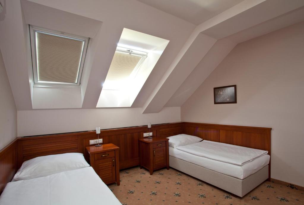 Postel nebo postele na pokoji v ubytování Hotel Tacl