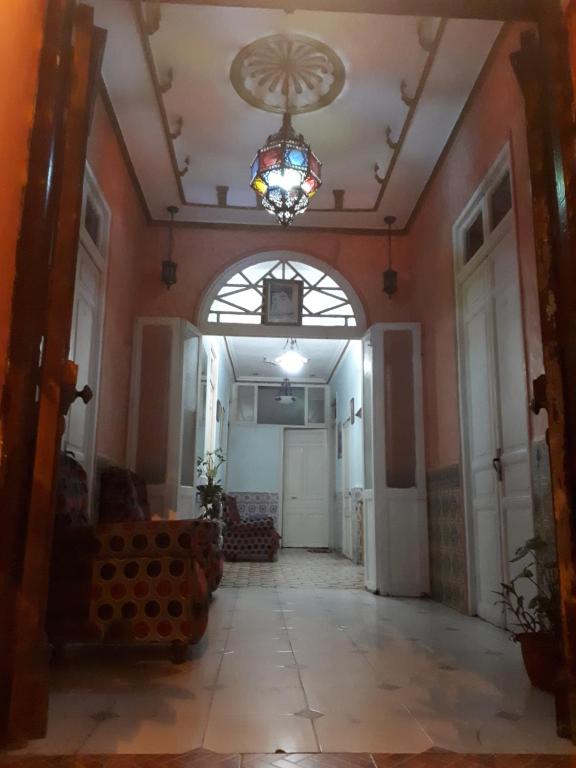 a hallway of a building with a chandelier at Pension Safari in Tangier
