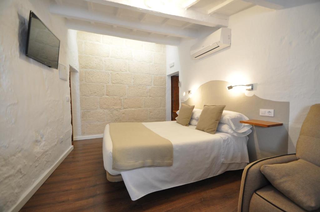 une chambre d'hôtel avec un lit et un canapé dans l'établissement Port Antic Ciutadella by My Rooms Hotels, à Ciutadella