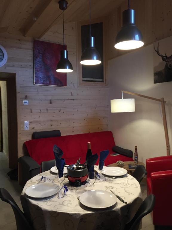 a table with plates and a pot on top at Le petit Saint Bernard in Sainte-Foy-Tarentaise