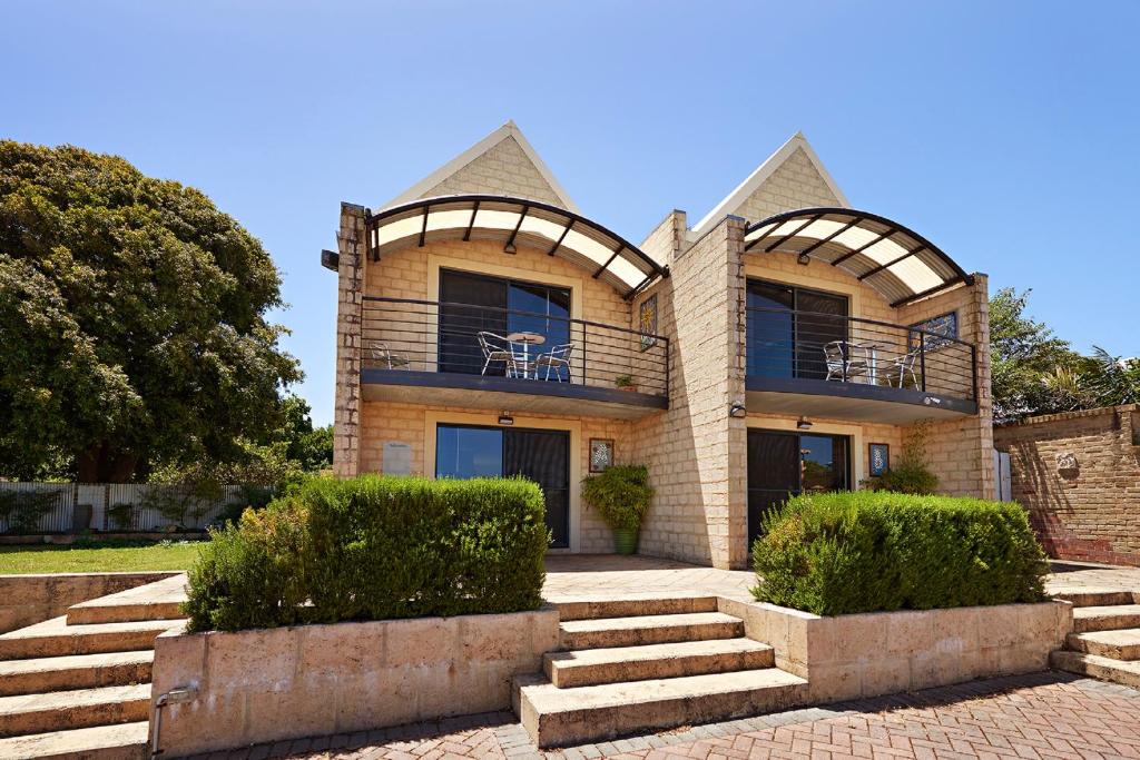 a house with a staircase in front of it at Albany Harbourside Apartments And Houses in Albany