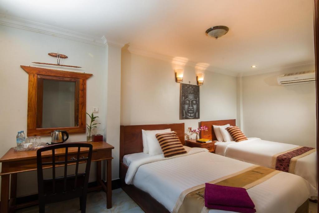 Postel nebo postele na pokoji v ubytování Angkor Udom Guesthouse