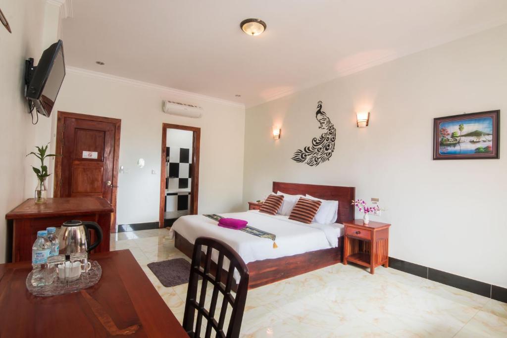 Postel nebo postele na pokoji v ubytování Angkor Udom Guesthouse