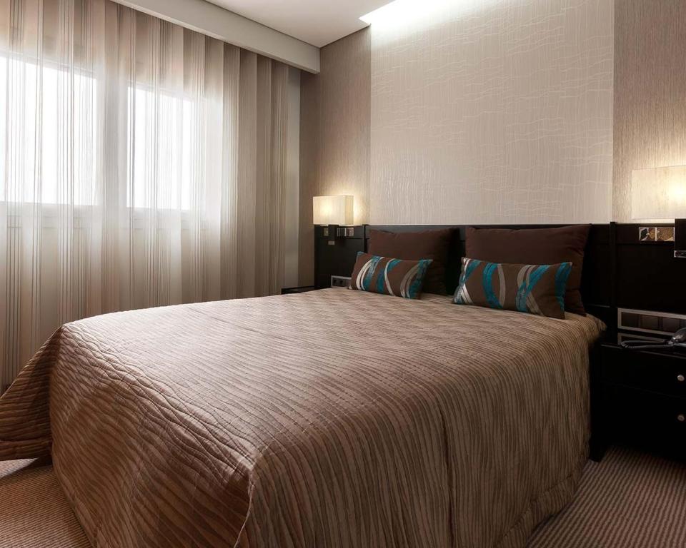 Postel nebo postele na pokoji v ubytování Cardal Hotel