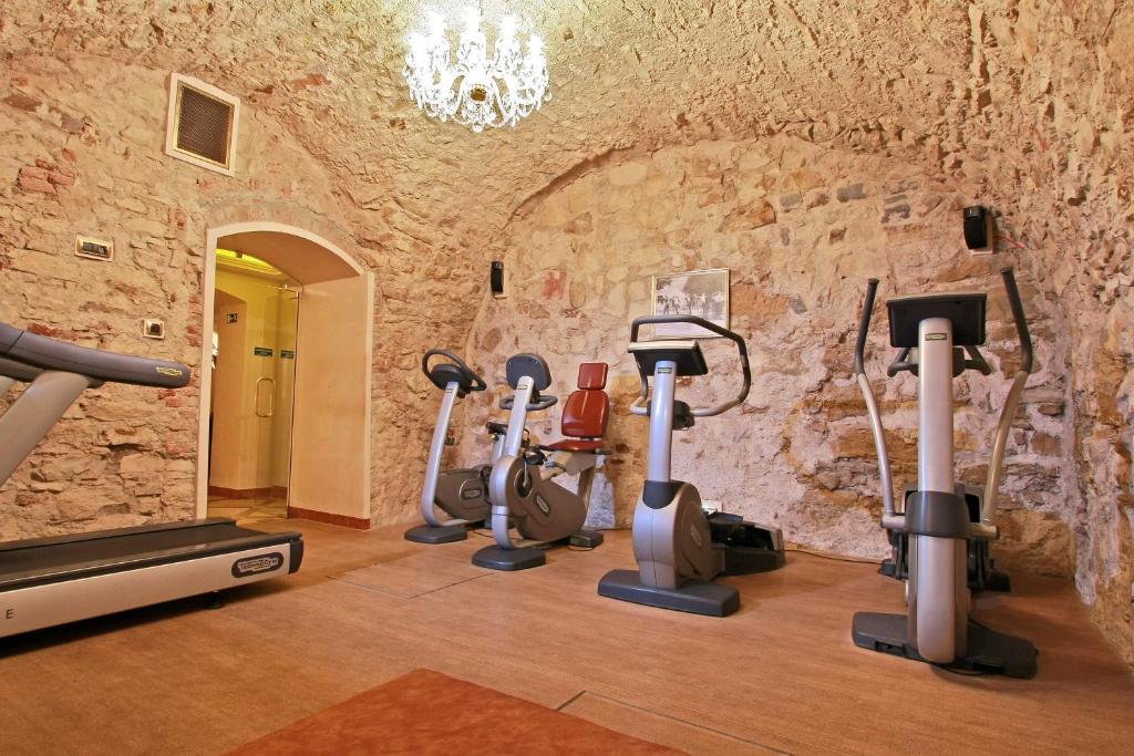 a gym with cardio equipment in a stone wall at Alchymist Grand Hotel and Spa - Preferred Hotels & Resorts in Prague