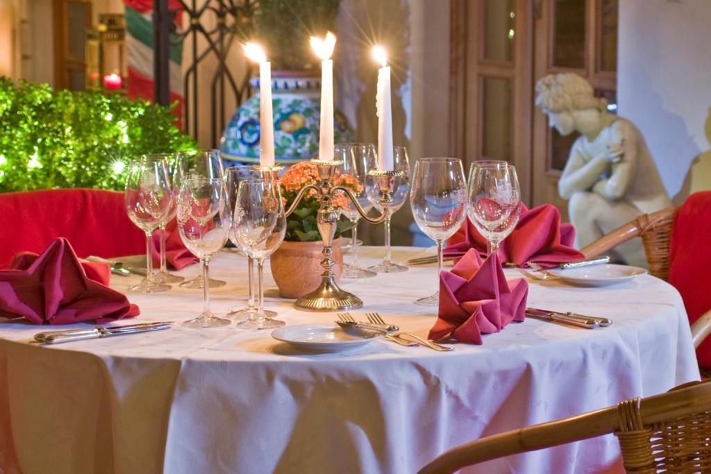 a table with wine glasses and napkins on it at Alchymist Grand Hotel and Spa - Preferred Hotels & Resorts in Prague