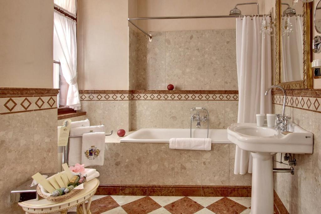 a bathroom with a bath tub and a sink at Alchymist Grand Hotel and Spa - Preferred Hotels & Resorts in Prague