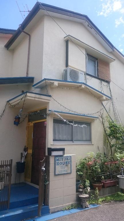a house with a for rent sign in front of it at Miyuki House Hostel 1 in Kashiwa