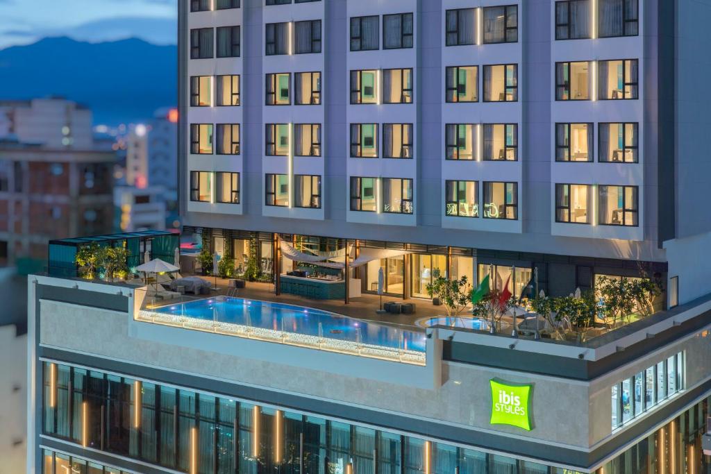 an aerial view of a building with a swimming pool at ibis Styles Nha Trang in Nha Trang