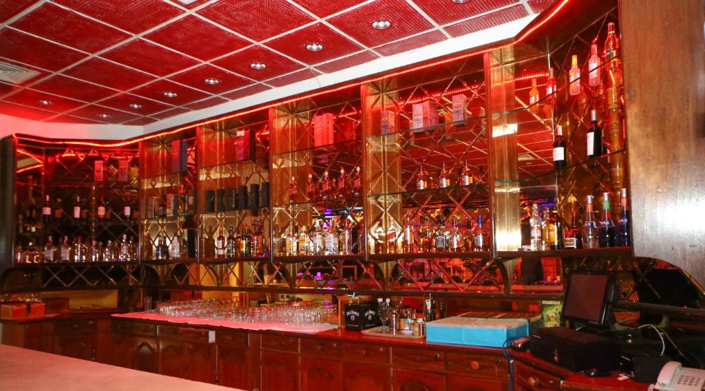 a bar with a lot of glasses on the wall at Fujairah Hotel & Resort in Fujairah