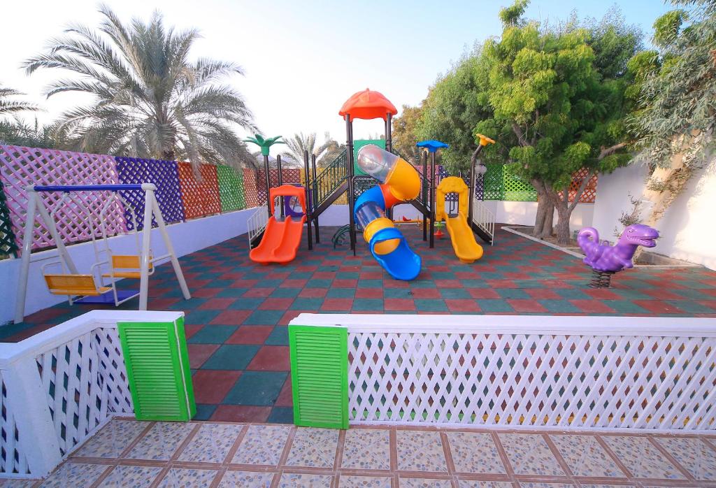 a childrens playground with slides and play equipment at Fujairah Hotel & Resort in Fujairah