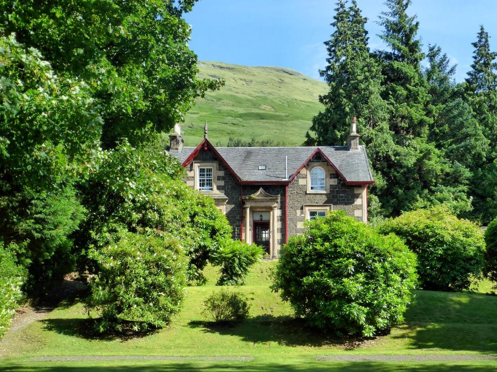 an old house with trees in front of it at Mansefield House in Arrochar