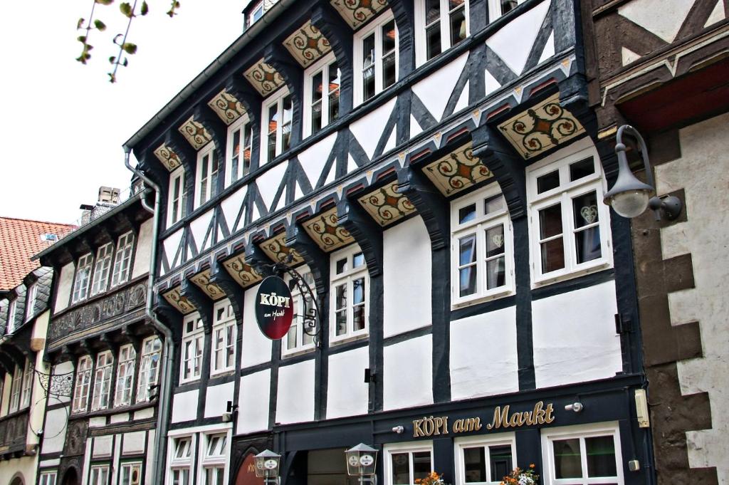 a black and white building with a sign on it at Köpi Appartements in Goslar