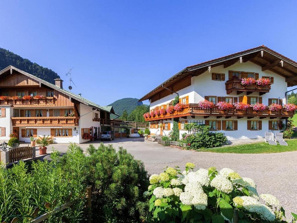 a large building with flowers in front of it at Gästehaus Pfnürlehen in Berchtesgaden