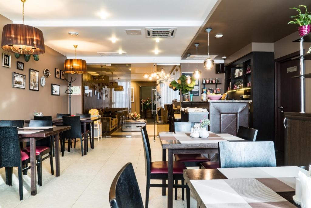a dining room with tables and chairs in a restaurant at Business Hotel Diplomat in Nizhny Novgorod