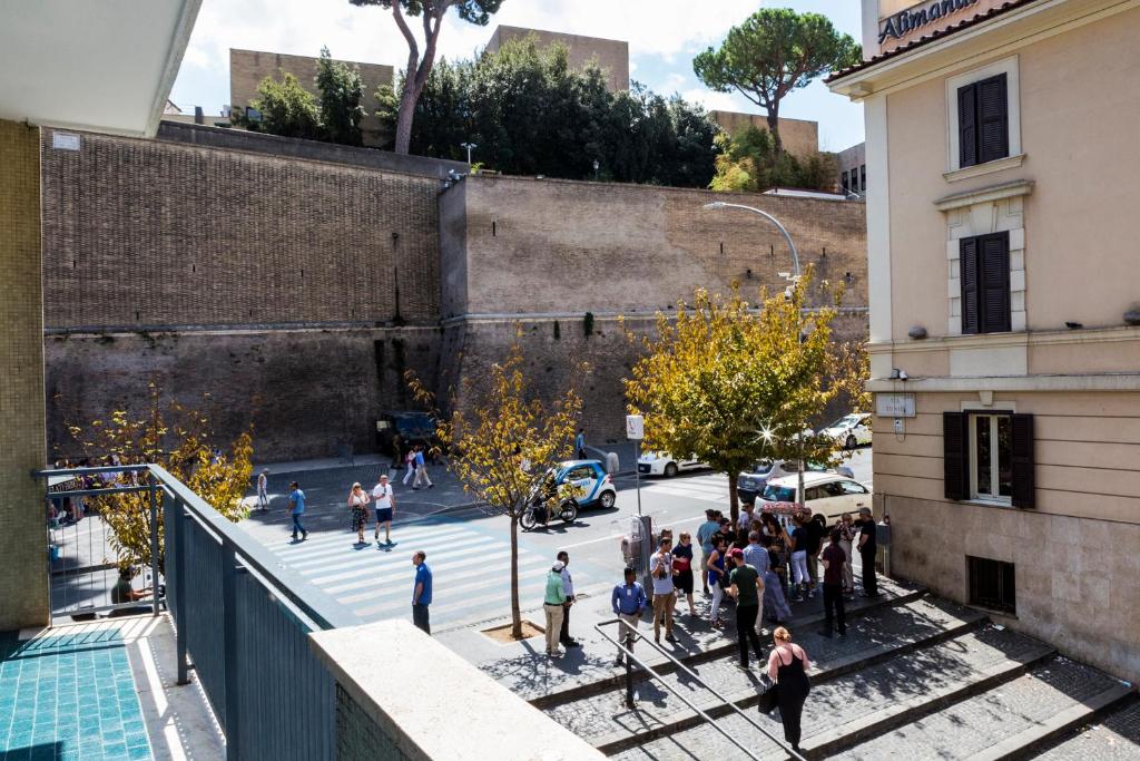 a group of people walking down a street at My Tiny Home in Rome