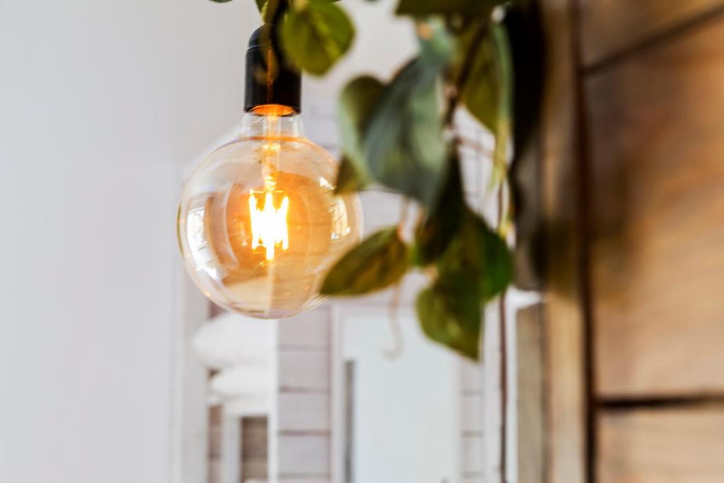 a light bulb with a candle in it hanging at My Tiny Home in Rome