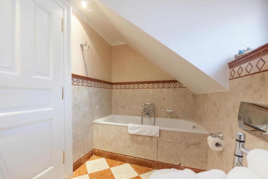 a bathroom with a tub and a sink at Alchymist Grand Hotel and Spa - Preferred Hotels & Resorts in Prague