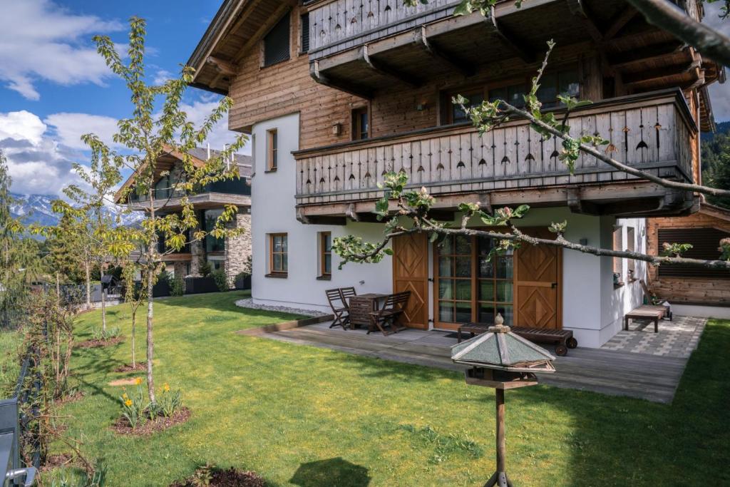 an exterior view of a house with a yard at Steinberghaus Apartments in Leogang