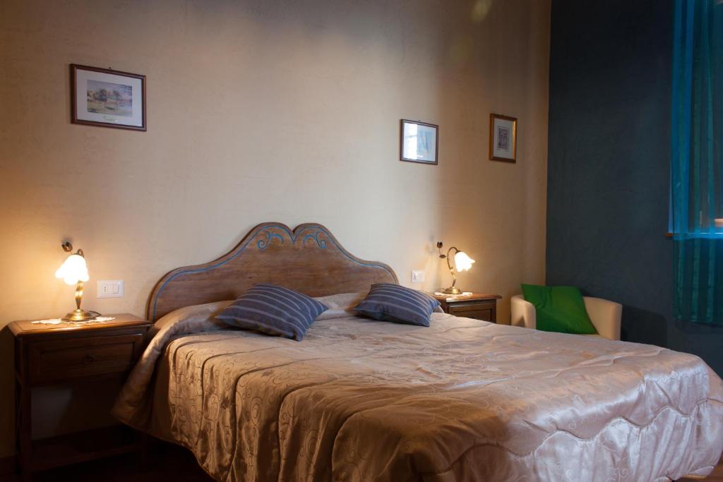 1 dormitorio con 1 cama con 2 almohadas en B&B Le Caselle "Il Baraccotto", en Lucignano