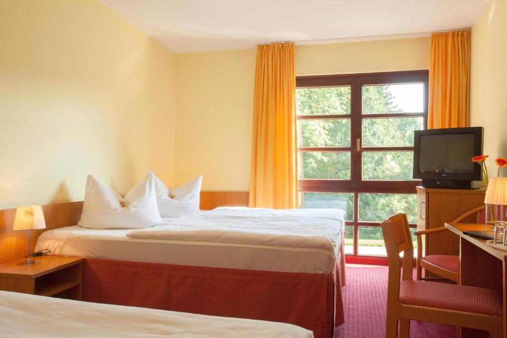 Postel nebo postele na pokoji v ubytování Kim Hotel Im Park