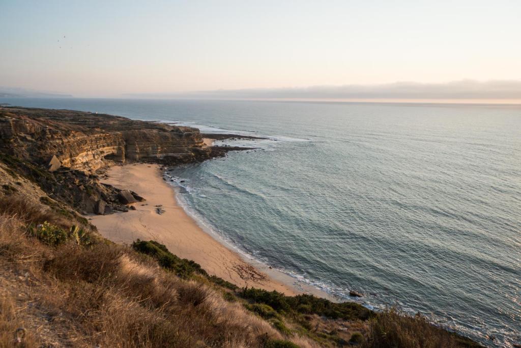an aerial view of a beach next to the ocean at Beach House Ericeira in Ericeira