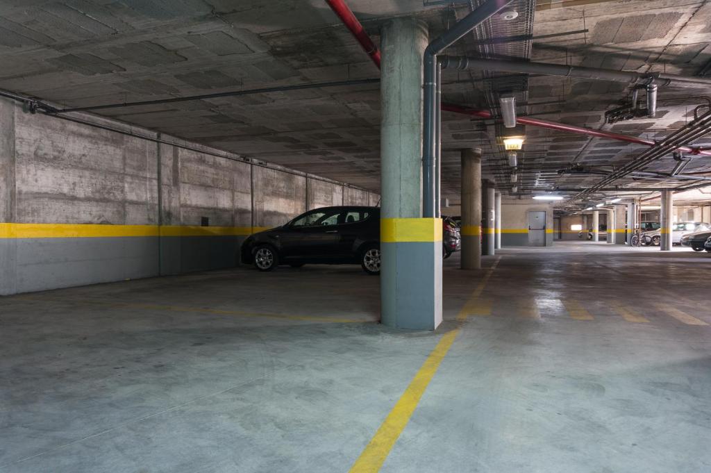 a parking garage with a car parked in it at Beach House Ericeira in Ericeira