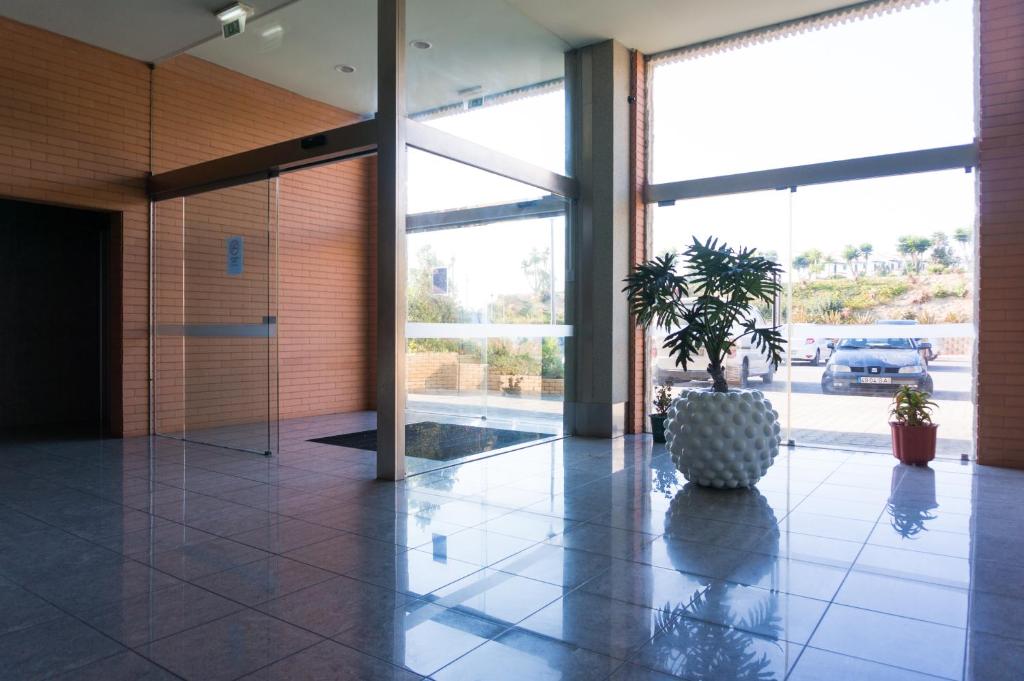a hallway with a potted plant in a building at Beach House Ericeira in Ericeira
