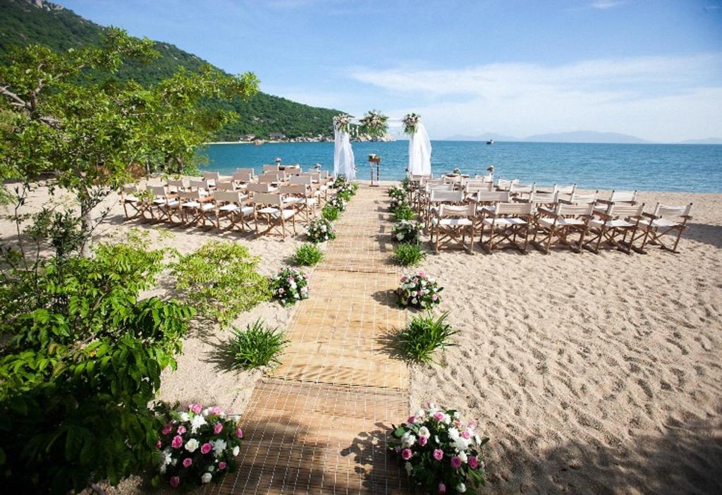 a wedding on the beach with chairs and a aisle at Six Senses Ninh Van Bay in Ninh Van Bay