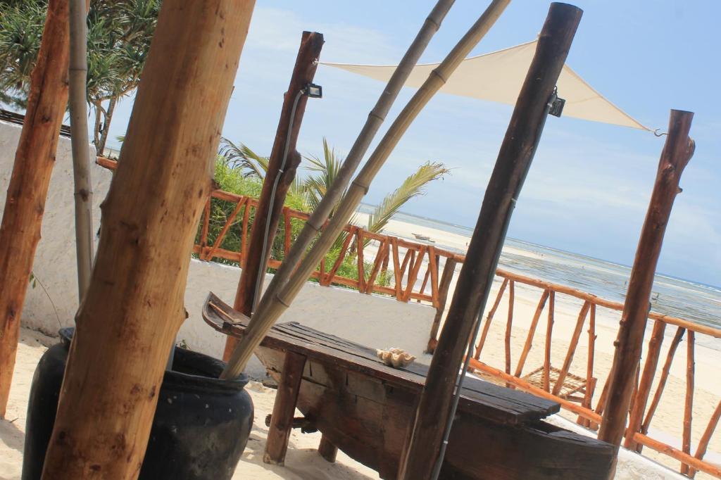 a bench on the beach with the ocean in the background at Villa Marisella in Kiwengwa