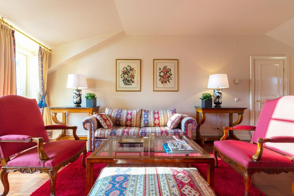 a living room with a couch and two chairs at Stikliai Palace Residence in Vilnius