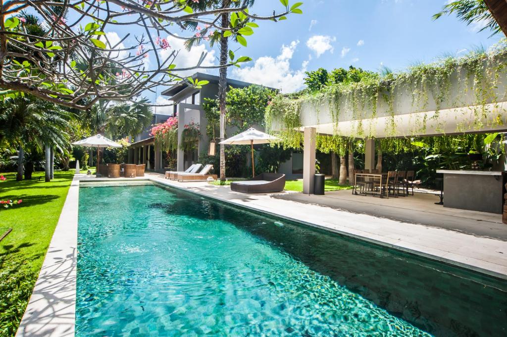 a swimming pool in the backyard of a house at Kamehameha Luxury Villa in Seminyak