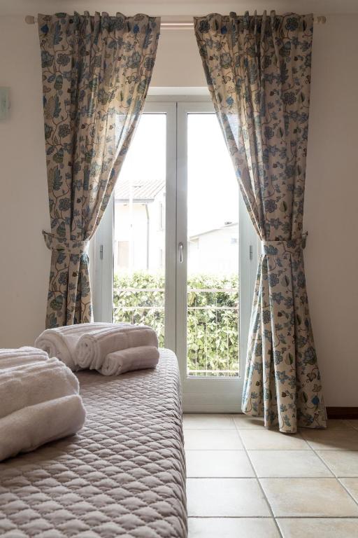 Postel nebo postele na pokoji v ubytování Le Campane di Assisi