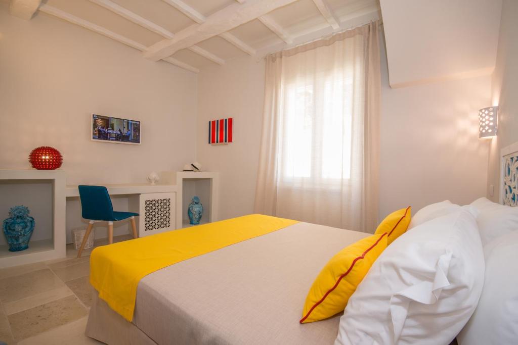 Postel nebo postele na pokoji v ubytování Palazzo Maringelli