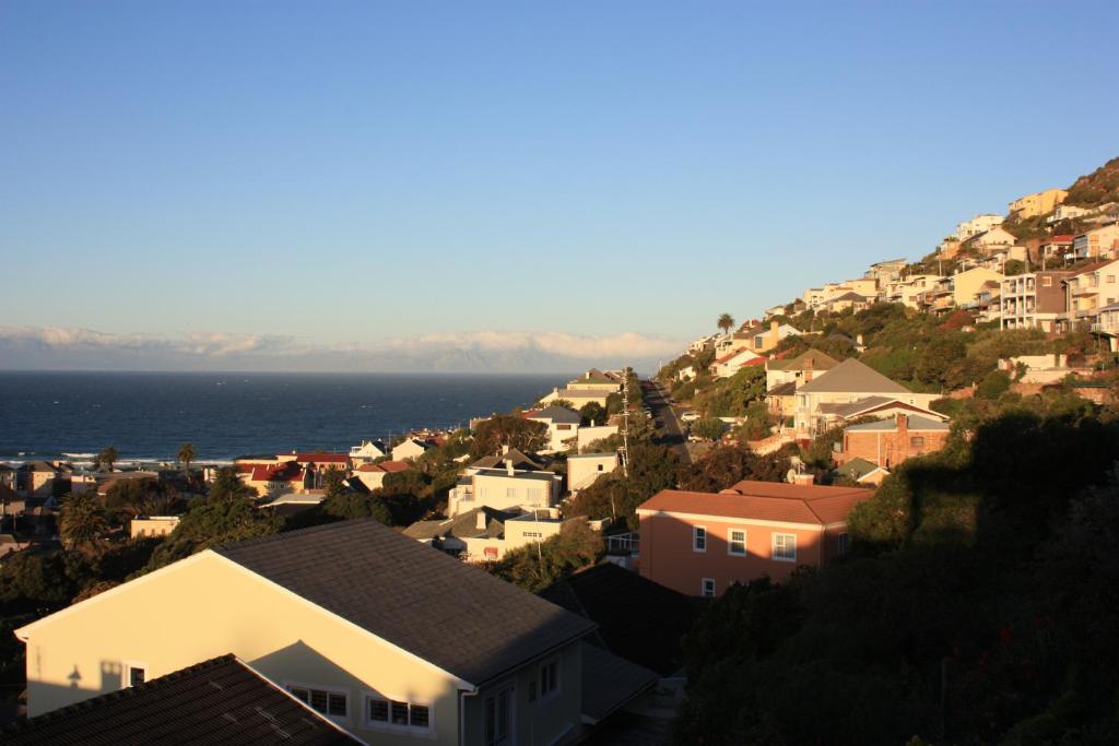a town on a hill with the ocean in the background at Salop House in Fish Hoek
