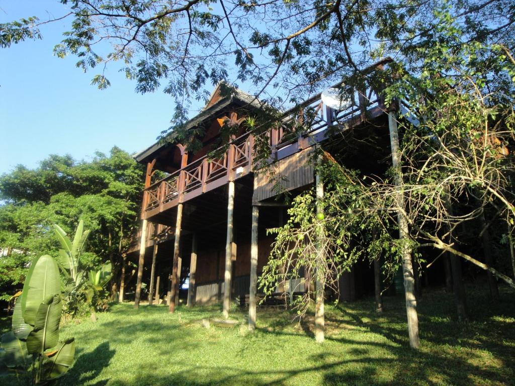 a tree house with a balcony on the side of it at House 37 Nkululeko in Sodwana Bay Lodge - no loadshedding in Sodwana Bay