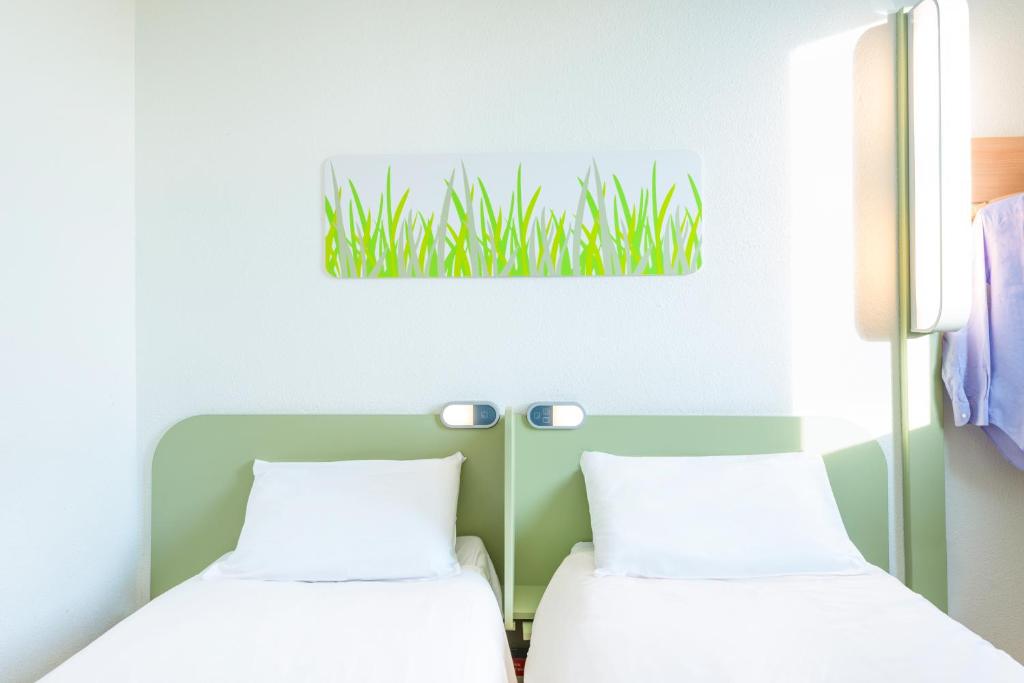 Postel nebo postele na pokoji v ubytování Ibis Budget Hyères