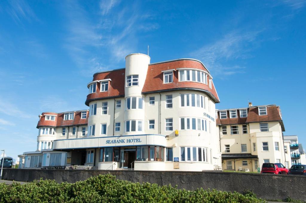 a large building with a clock on top of it at Seabank Hotel in Porthcawl