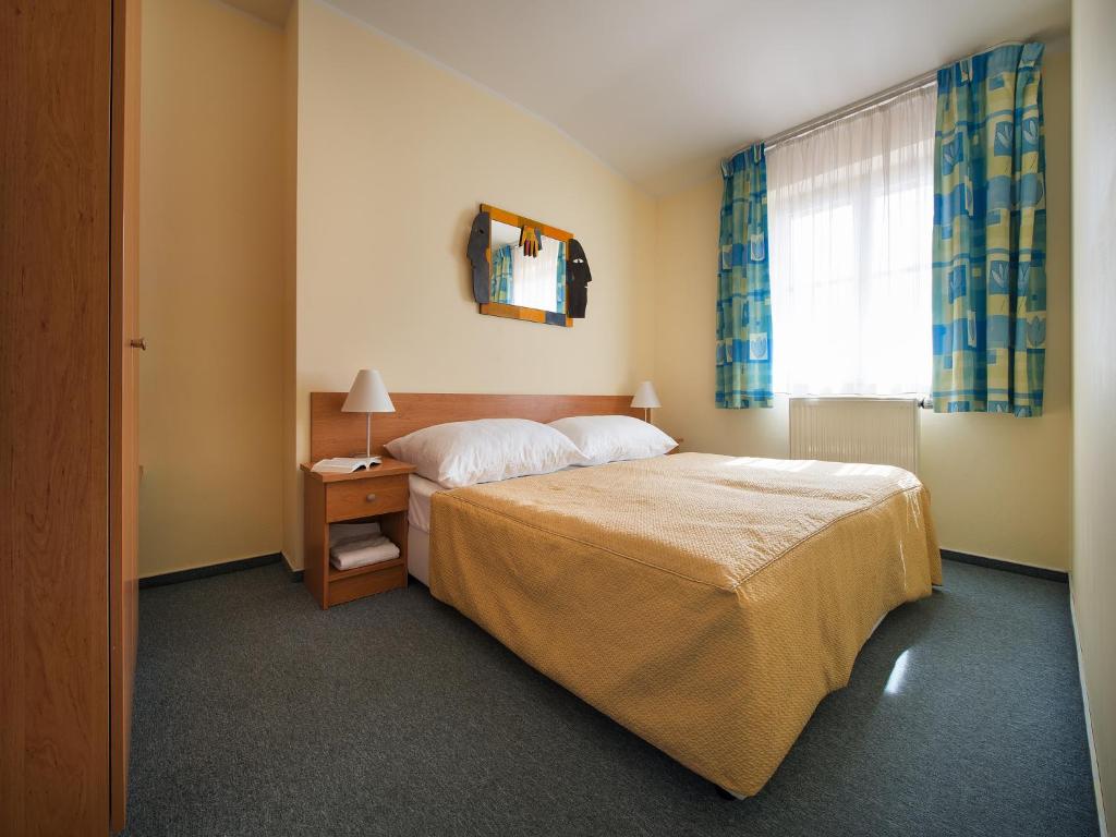 Postel nebo postele na pokoji v ubytování EA Hotel Tosca