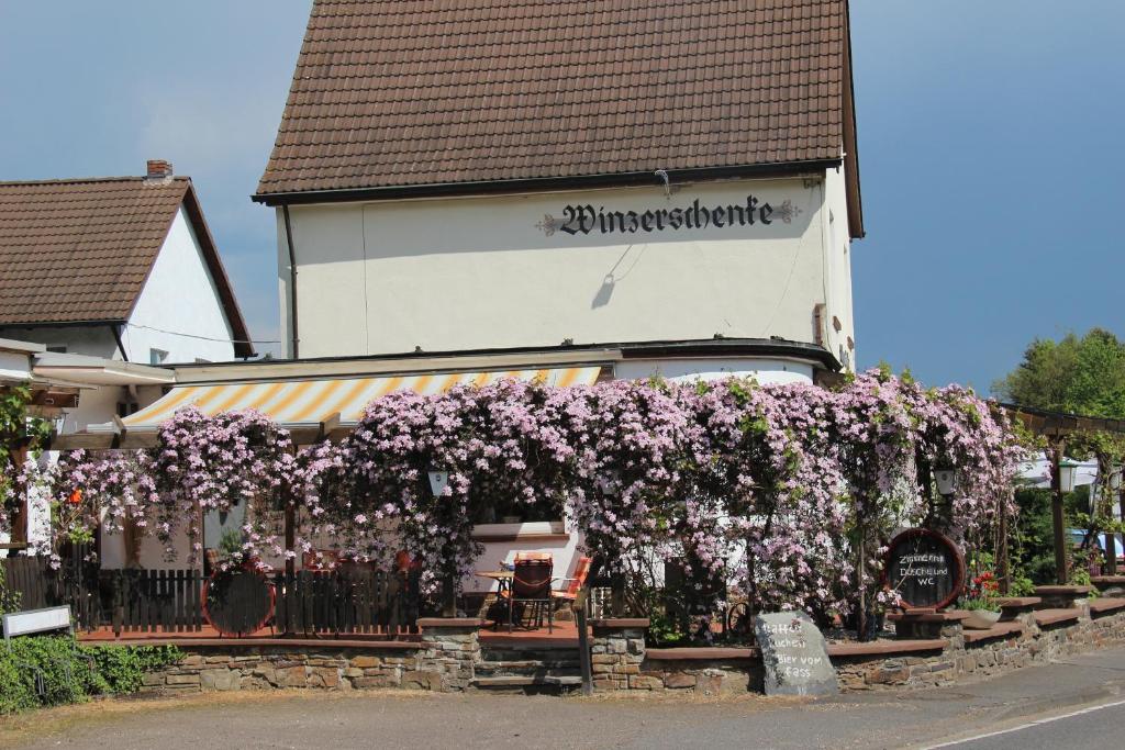 a building with a bunch of purple flowers on it at Winzerschenke in Walporzheim