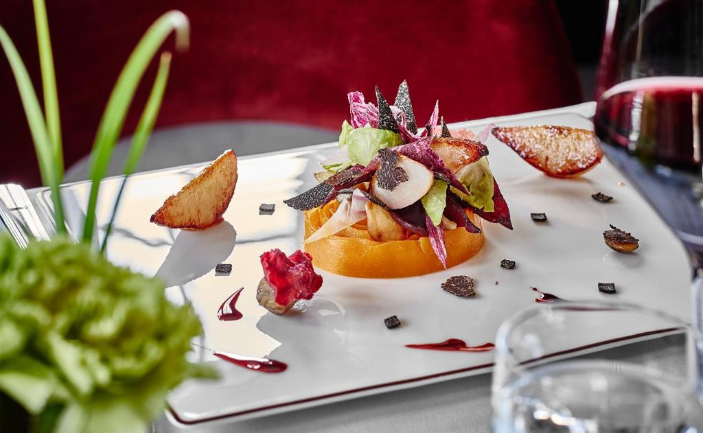a white plate with a dessert on a table at Apogée Courchevel, Oetker Hotels in Courchevel