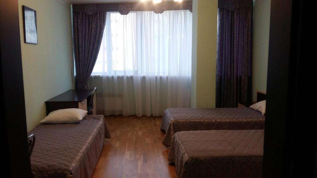 Postel nebo postele na pokoji v ubytování Hotel Obolon-Arena