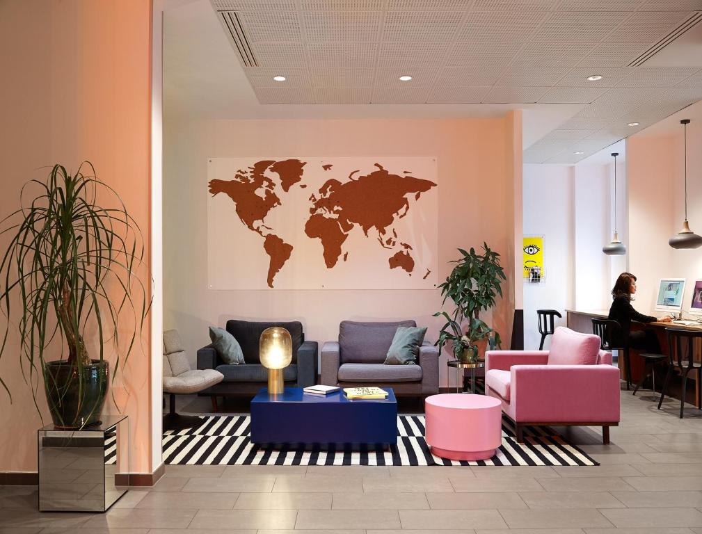 a lobby with a map of the world on the wall at The Social Hub Paris La Défense in Puteaux