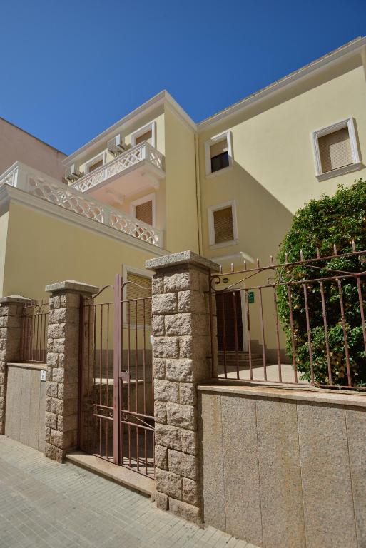 a house with a gate and a fence at Liberty Guest House in Alghero