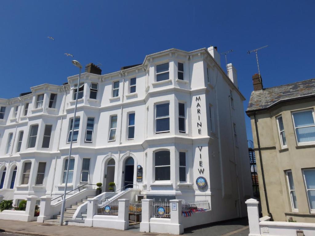 a large white building with a sign on it at Marine View Guest House in Worthing