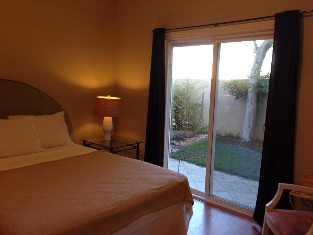 a bedroom with a bed and a sliding glass door at Redondo Beach / Hermosa Beach in Redondo Beach