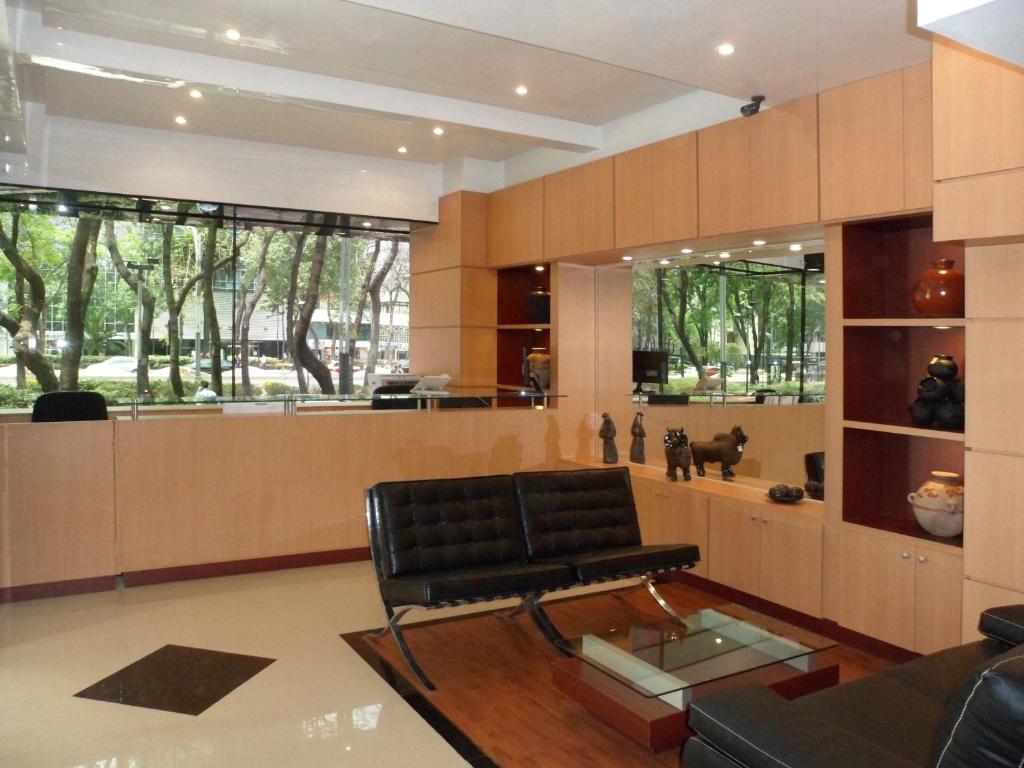 A wood-paneled lounge faces leafy street views through broad windows.