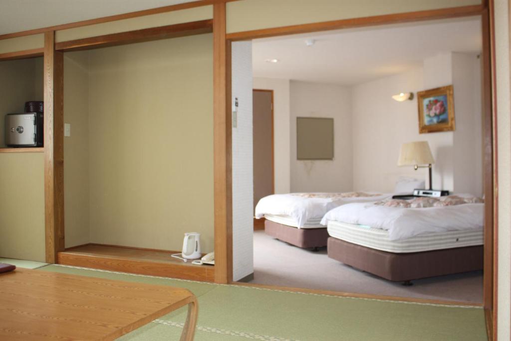 Postel nebo postele na pokoji v ubytování Hotel Higashidate