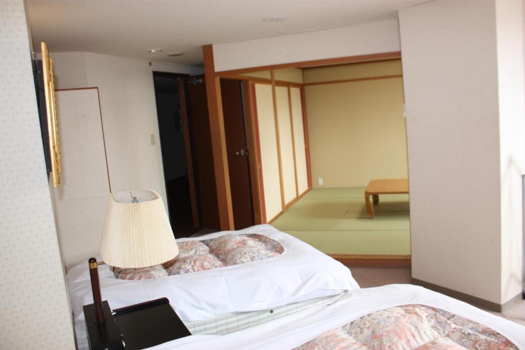 Postel nebo postele na pokoji v ubytování Hotel Higashidate