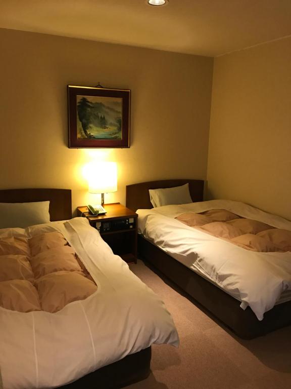 Postel nebo postele na pokoji v ubytování Hotel Higashidate
